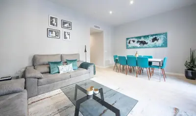 a living room with a couch and a table at Apartamento 4 dormitorios en Calle Roselló You Stylish Apartments in Barcelona