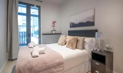 a bedroom with a large bed with white sheets and pillows at Apartamento 4 dormitorios en Calle Roselló You Stylish Apartments in Barcelona