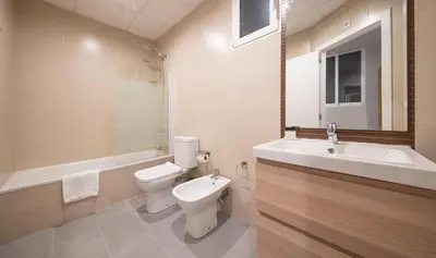 a bathroom with a toilet and a sink and a tub at Apartamento 4 dormitorios en Calle Roselló You Stylish Apartments in Barcelona