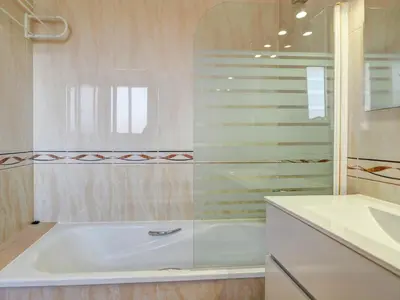 a bathroom with a tub and a sink at Ribes Duplex by Hello Homes Sitges in Sitges