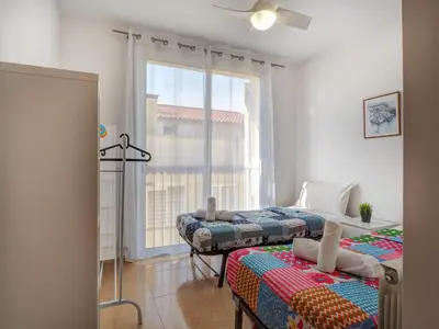 a bedroom with two beds and a window at Ribes Duplex by Hello Homes Sitges in Sitges