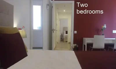 a room with a bed and a dining room with a table at BruStar Sagrada Familia in Barcelona