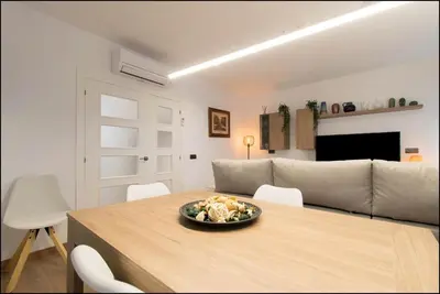 a living room with a table with a bowl of food on it at Sitges Oasi in Sitges