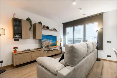 a living room with a couch and a flat screen tv at Sitges Oasi in Sitges