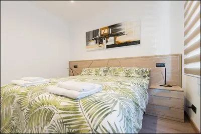 a bedroom with a bed with two towels on it at Sitges Oasi in Sitges