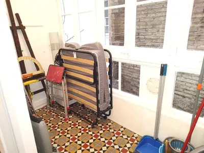 a room with a bench in a room with windows at Spacious aptmt close to Pl Universidad and Pl Catalunya, 2,5 bedrooms, balcony, heating, elevator Min 31 nights in Barcelona