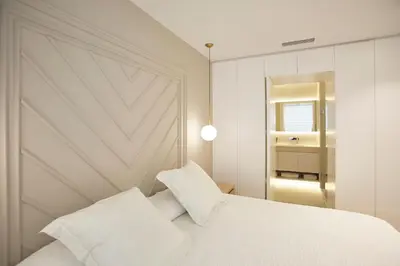 a bedroom with a white bed and a mirror at Apartamento en Pedralbes in Barcelona