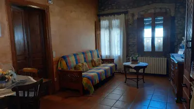 a living room with a couch and a table at Can Bicicleta de Dalt in Olesa de Bonesvalls