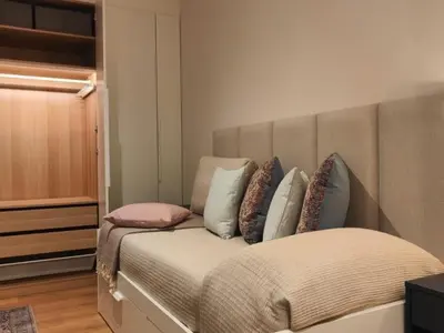 a bedroom with a bed with pillows on it at Gran Vía de Carlos III B in Barcelona