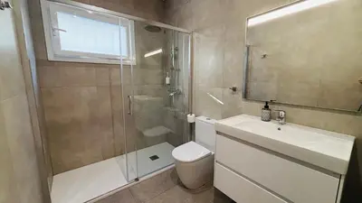 a bathroom with a shower and a toilet and a sink at Apartamento familiar by prestigi in Terrassa