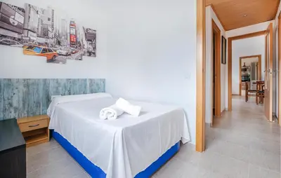 a bedroom with a bed with white sheets and towels at Cozy Home In Calafell With Wifi in Calafell