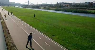 a group of people walking down a road at Playa a pie y a 15 minutos de Ramblas y Plaza Catalunya en metro in Sant Adria de Besos