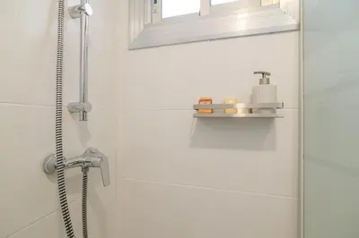 a bathroom with a shower with a shower head at Playa a pie y a 15 minutos de Ramblas y Plaza Catalunya en metro in Sant Adria de Besos