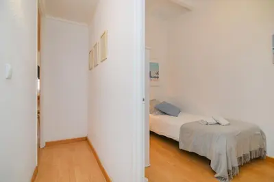 a white room with two beds in a room at Playa a pie y a 15 minutos de Ramblas y Plaza Catalunya en metro in Sant Adria de Besos