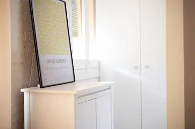 a framed picture sitting on top of a white cabinet at Stay U-nique Apartments Llibertat in Barcelona