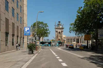 a city street with a clock tower in the distance at Stay U-nique Apartment Creu Coberta in Barcelona