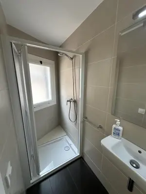 a small bathroom with a shower and a sink at LEsglesia 1 in Arenys de Mar