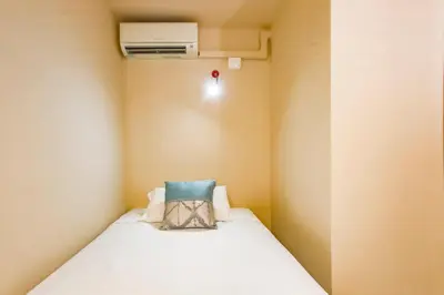 a small room with a bed and a air conditioner at Love in Cuba in Sitges