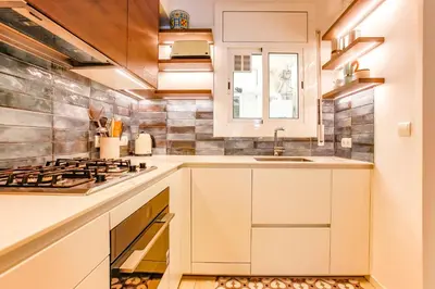 a kitchen with white cabinets and a sink at Love in Cuba in Sitges