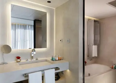 a bathroom with a sink and a tub and a mirror at ABaC H&R Barcelona Monument in Barcelona