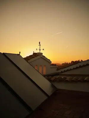 a sunset on the roof of a church at Soul Farm Mas els Igols in Torrellas de Foix