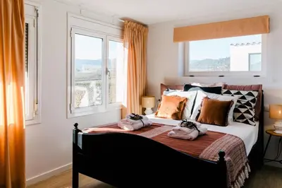 a bedroom with a bed with two towels on it at Soul Farm Mas els Igols in Torrellas de Foix