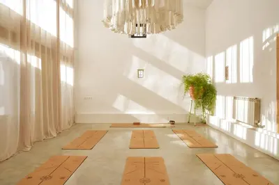 a hallway with mats on the floor in a room with windows at Soul Farm Mas els Igols in Torrellas de Foix