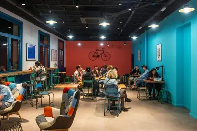 a group of people sitting at tables in a room at Safestay Barcelona Passeig de Gràcia in Barcelona