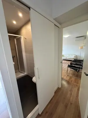 a room with a door leading to a bathroom at Esglesia 2 in Arenys de Mar
