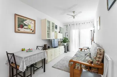 a living room with a table and a dining room at Perfect Apartment near the beach and Barcelona in Pineda de Mar