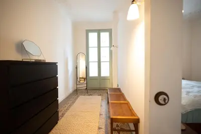 a bedroom with a dresser and a door with a mirror at Stylish Retreat in Catalonia in Barcelona
