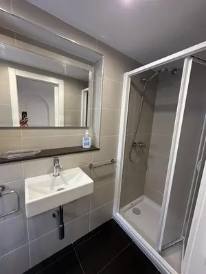 a bathroom with a shower and a sink and a mirror at L'Esglesia 3 in Arenys de Mar