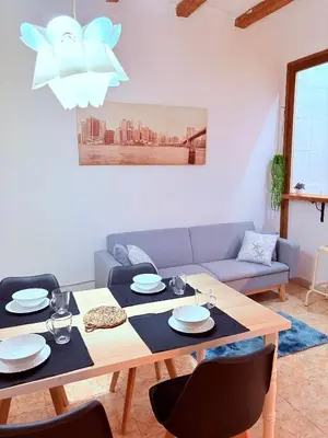 a living room with a table and a couch at Amazing and stylish flat for 4 people with breakfast included 2 blocks away from Poblenou beach in Barcelona