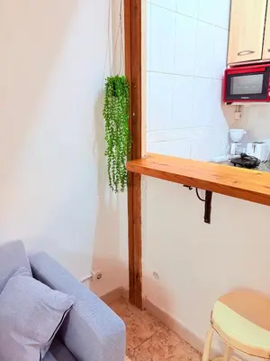 a living room with a blue couch and a window at Amazing and stylish flat for 4 people with breakfast included 2 blocks away from Poblenou beach in Barcelona