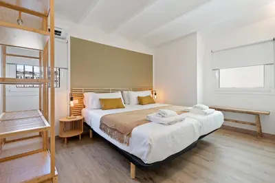 a bedroom with a large bed with white sheets at Flateli Pelayo H7 in Barcelona