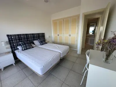 a small bedroom with a bed and a table at Can Xifre 1 in Arenys de Mar