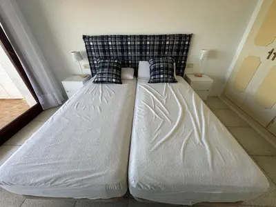 a bed with white sheets and pillows in a room at Can Xifre 1 in Arenys de Mar