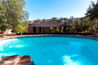 a large blue swimming pool with a gazebo at Catalunya Casas Unique villa in Costa Maresme 27km to Barcelona! in Argentona