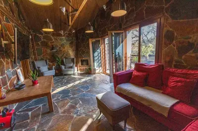a living room with a red couch and a stone wall at Catalunya Casas Unique villa in Costa Maresme 27km to Barcelona! in Argentona