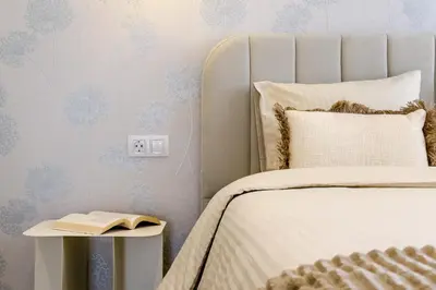 a bedroom with a bed and a book on a side table at Novus Homes Barcelona Plaza España in Barcelona