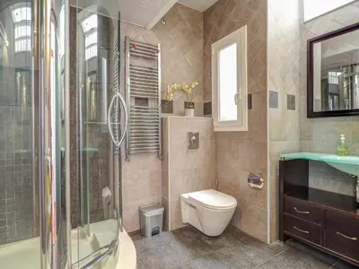 a bathroom with a toilet and a shower and a sink at Ollie Apartment by Hello Homes Sitges in Sitges