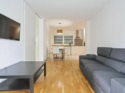 a living room with a couch and a table at Winahost Barcelona Pedralbes in Barcelona