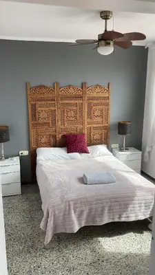a bedroom with a large bed with a wooden headboard at Masnou nice view big apartment in Masnou