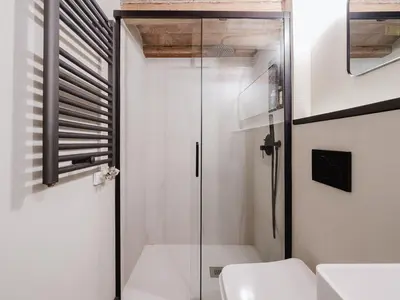a bathroom with a glass shower and a toilet at Luxury 2 Story Apartment Near Passeig de Gracia in Barcelona