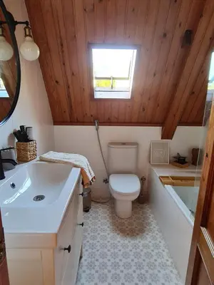 a bathroom with a toilet and a sink at Villa cascada in Sant Cebrià de Vallalta