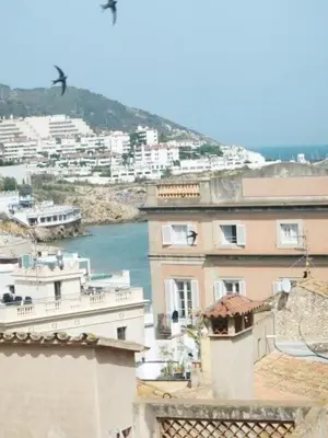 a view of a city with a river and buildings at Pis Sitges centre in Sitges