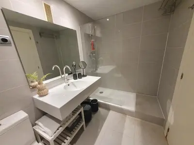 a bathroom with a sink and a mirror at Modern apartment in Diagonal Mar in Barcelona
