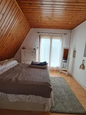 a bedroom with a large bed and a window at Villa cascada in Sant Cebrià de Vallalta