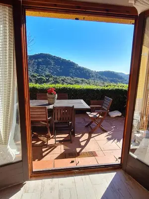 a view of a patio with a table and chairs at Villa cascada in Sant Cebrià de Vallalta