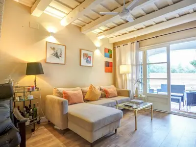 a living room with a couch and a table at Masia Las Torres by Hello Homes Sitges in Sitges